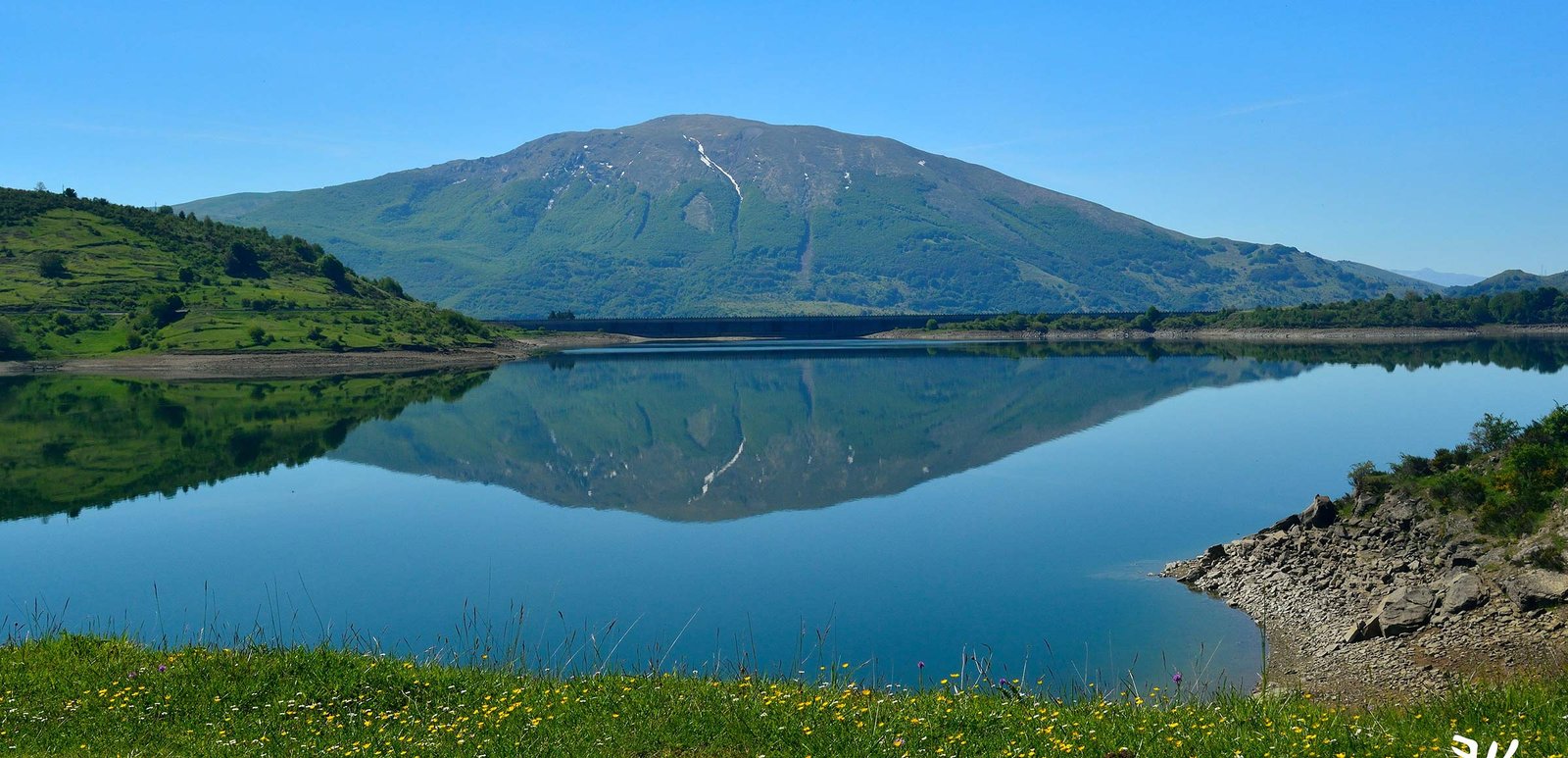 Panoramic view of a mountain reservoir with calm water